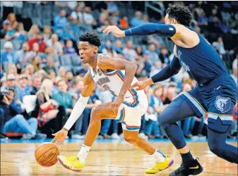  ??  ?? Oklahoma City's Shai Gilgeous-Alexander, left, goes past Memphis' Dillon Brooks during Wednesday's exhibition game at Chesapeake Energy Arena. [BRYAN TERRY/ THE OKLAHOMAN]