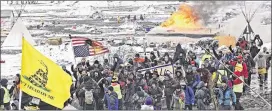  ?? TOM STROMME / THE BISMARCK TRIBUNE VIA AP ?? A fire set by protesters burns as opponents of the Dakota Access pipeline leave their main protest camp on Feb. 22 near Cannon Ball, N.D. The Sioux Indian tribe returned to court Tuesday to keep the pipeline from carrying oil.