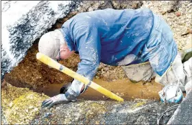  ??  ?? Rocky Mills gets his hand inside a broken 3-inch water pipe June 10 after Decatur’s Water Department tried to locate a broken water line since June 5. The pipe ran under a larger 12-inch culvert (under Mills’ right hand) which was buried under the northbound lane of Arkansas 59 near Grand Savings Bank in Decatur.
(NWA Democrat-Gazette/Mike Eckels)