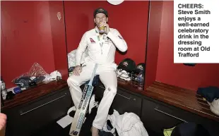  ??  ?? CHEERS: Steve Smith enjoys a well-earned celebrator­y drink in the dressing room at Old Trafford