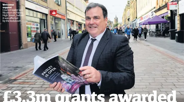  ??  ?? Welcome support
Council leader Iain Nicolson on Paisley High Street , before it was affected by the lockdown