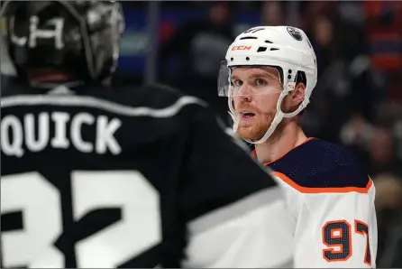  ?? The Associated Press ?? Edmonton Oilers centre Connor McDavid, right, looks at Los Angeles Kings goaltender Jonathan Quick during the third period of Game 4 Sunday in Los Angeles.