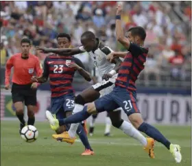  ?? JESSICA HILL — THE ASSOCIATED PRESS ?? United States’ Kellyn Acosta, left, and Matt Hedges, right, pressure Ghana’s Raphael Dwamena, center, during the first half of an internatio­nal friendly on July 1 at Pratt & Whitney Stadium at Rentschler Field in East Hartford, Conn.