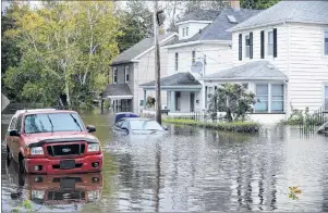  ?? CP PHOTO ?? A vehicle is submerged in south end Sydney after the area flooded due to heavy rainfall from a tropical storm in October 2016.