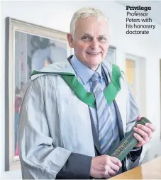  ??  ?? Privilege Professor Peters with his honorary doctorate