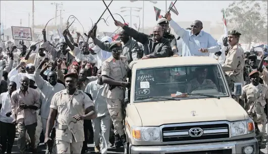  ?? Picture: REUTERS ?? CENTRE STAGE: Sudanese President Omar Hassan al-Bashir (on vehicle, centre) parades through the street in Al-Fasher, northern Darfur, in this March 2009 file picture. If South Africa didn’t want to arrest him, we needed to first get out of the treaty...