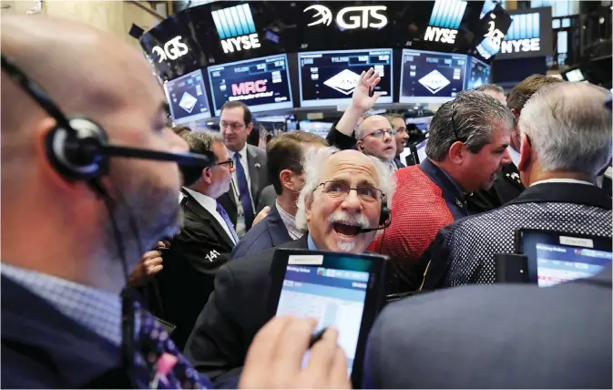  ??  ?? NEW YORK: Traders work on the floor of the New York Stock Exchange (NYSE) the morning after Donald Trump won a major upset in the presidenti­al election yesterday in New York City. — AFP