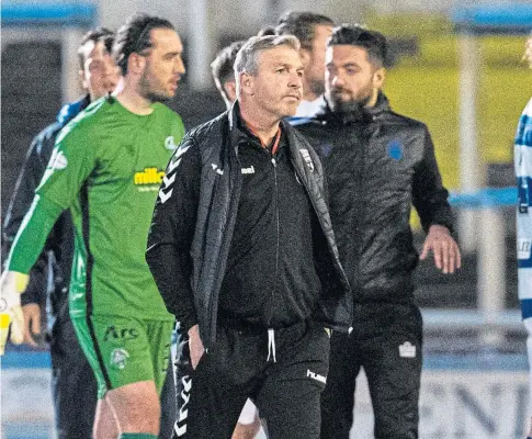  ??  ?? SICKENER: Montrose manager Stewart Petrie trudges off at the end of Tuesday night’s play-off defeat to Morton.