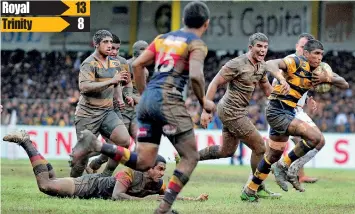  ??  ?? A Royal player advances under heavy underfoot conditions - Pix by Amila Gamage