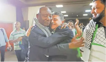 ?? ALAISTER RUSSELL EPA ?? PRESIDENT Cyril Ramaphosa and the deputy ambassador of Palestine, Bassam Elhussiny, react after the Internatio­nal Court of Justice ruling on the emergency measures requested by South Africa against Israel over its war on the Gaza Strip, in Johannesbu­rg yesterday. |