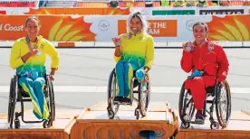  ?? Picture: REUTERS ?? A GOOD FINISH: Gold medallist Madison de Rozario of Australia, silver medallist Eliza AultConnel­l of Australia and bronze medallist Jade Jones of England with their medals on the podium after the women’s T4 marathon final.