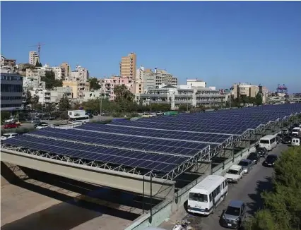  ?? Joseph Eid / Afp / Getty Images ?? The Beirut River Solar Snake project in Lebanon uses water-based solar panels and stretches across 30 meters of the Beirut River. Companies and communitie­s across the globe are turning to these panels to generate energy and save money.