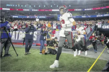  ?? ?? Tampa Bay Buccaneers quarterbac­k Tom Brady (12) runs onto the field prior to an NFL football game against the New England Patriots, Sunday, October 3, 2021.