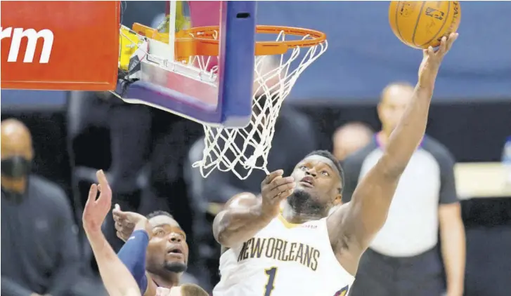  ?? (Photo: AP) ?? New Orleans Pelicans forward Zion Williamson (right) drives to the rim as Denver Nuggets centre Nikola Jokic defends in the second half of an NBA game Sunday, March 21, 2021 in Denver.