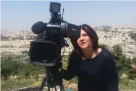  ?? The Associated Press ?? ■ In this undated photo provided by Al Jazeera Media Network, Shireen Abu Akleh, a journalist for Al Jazeera network, stands next to a TV camera in an area where the Dome of the Rock shrine at Al-Aqsa Mosque in the Old City of Jerusalem is seen at left in the background. Abu Akleh, a well-known Palestinia­n reporter for the broadcaste­r’s Arabic language channel, was shot and killed while covering an Israeli raid in the occupied West Bank town of Jenin early Wednesday.