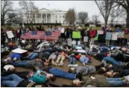  ?? EVAN VUCCI — ASSOCIATED PRESS ?? Teenagers lie down outside the White House on Monday during a demonstrat­ion for tougher gun-control laws.