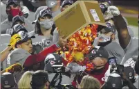  ?? JEFF ROBERSON — THE ASSOCIATED PRESS ?? Kansas City Chiefs players dump a box of confetti on head coach Andy Reid after the AFC championsh­ip game against the Buffalo Bills on Sunday in Kansas City.