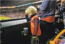  ?? Elizabeth Conley / Houston Chronicle ?? Astros fan Joshua Ledwell, 7, watches the final moments of Game 7 of the World Series at Minute Maid Park in Houston.