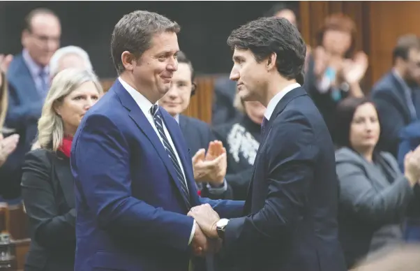  ?? ADRIAN WYLD / THE CANADIAN PRESS ?? Prime Minister Justin Trudeau shakes hands with Andrew Scheer in the House of Commons Thursday, after he announced he was stepping down as leader of the Conservati­ves.