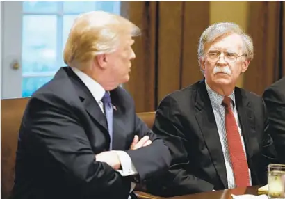  ?? Olivier Douliery TNS ?? PRESIDENT TRUMP has responded angrily to news reports that a forthcomin­g book by his former national security advisor, John Bolton, right, contains allegation­s that Trump withheld Ukrainian aid to get help in investigat­ing Joe Biden.