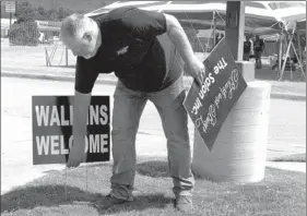  ?? LYNN KUTTER ENTERPRISE-LEADER ?? Dan Ledbetter, Farmington’s public works director, removes signs in violation of the city Sign Ordinance. A new committee is being formed to review the ordinance to make it more business friendly. These signs were too close to the curb.