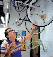  ?? STAFF PHOTO BY ALLISON SHIRK ?? Jacobo Salazar Jr., 42, and owner of Kickstand Bicycles in St. Elmo, checks out one of the bikes at his new shop at 3800 St. Elmo Ave., Suite 129. Salazar is holding an open house Saturday from 3 to 8 p.m. for local supporters. Food and drinks will be provided.