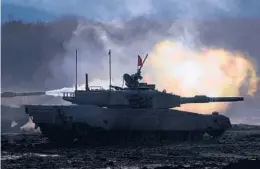  ?? EUGENE HOSHIKO/AP ?? A Japanese Type 90 tank fires at a target during a drill this month in Eniwa on the northern Japanese island of Hokkaido.