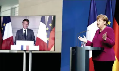  ??  ?? Angela Merkel and Emmanuel Macron at a joint video conference. ‘Both have recognised that unless the burden of reconstruc­tion is seen to be genuinely shared, there will be existentia­l implicatio­ns for the future of the EU.’ Photograph: Reuters