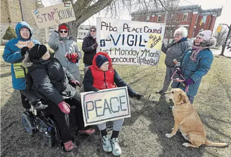  ?? CLIFFORD SKARSTEDT METROLAND ?? Members of the Peterborou­gh Peace Council, including organizer Margaret Slavin, second from left at the back, hold a peace vigil at the corner of George and McDonnel streets on Monday. The vigil marked the ninth anniversar­y of monthly vigils on the last Monday of the month that began in March 2015.