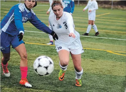  ?? BERND FRANKE THE ST. CATHARINES STANDARD ?? Niagara's Michelle Maecker, right, races to keep the ball in play in women's college soccer playoff action versus George Brown Saturday at Youngs Sportplex in Welland.