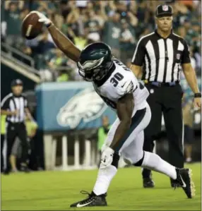  ?? MICHAEL PEREZ — THE ASSOCIATED PRESS ?? Corey Clement celebrates after scoring on a 6-yard run for a touchdown Thursday.