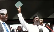  ??  ?? KENYAN OPPOSITION LEADER Raila Odinga holds a Bible as he takes a symbolic presidenti­al oath of office in Nairobi on January 30.