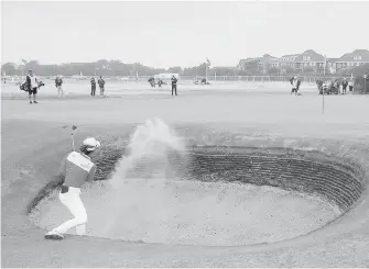  ??  ?? Australia’s Minjee Lee chips out of a bunker into another on the 16th during Day 2 of the Women’s British Open in Lytham, England, on Friday.