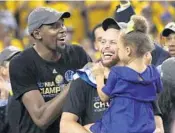  ?? EZRA SHAW/GETTY IMAGES ?? Kevin Durant, left, and Stephen Curry of the Golden State Warriors celebrate their championsh­ip on Monday.