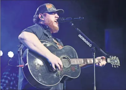  ?? [LAURA ROBERTS/INVISION] ?? Luke Combs performing recently at Ryman Auditorium in Nashville, Tenn.