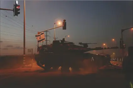  ?? AP PHOTO/OHAD ZWIGENBERG ?? ISRAELI TANKS HEAD TOWARD the Gaza Strip border in southern Israel on Thursday.