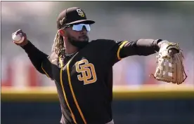  ?? CHARLIE RIEDEL — THE ASSOCIATED PRESS ?? San Diego Padres’ Fernando Tatis Jr. throws during spring training baseball practice, Feb. 23, in Peoria, Ariz.