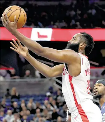  ?? John Raoux / Associated Press ?? James Harden gets past Orlando’s Terrence Ross for a layup in Friday’s win. Harden hit 10-of-15 from long range and finished with 54 points, going over 50 for the fourth time in his past seven games.
