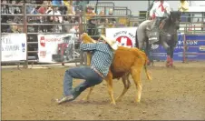  ?? ?? Maple Creek's Blake Link holds on and Val Marie's Riley Hayes tries to turn over his steer.