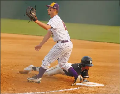  ?? Terrance Armstard/News-Times ?? Pickoff play: Junction City first baseman Bryce Ware awaits the throw as Smackover's Weston Smith slides back into first base during their clash in the finals of the 8-3A District Tournament at Smackover. On Thursday, the Dragons and Bucks will begin...