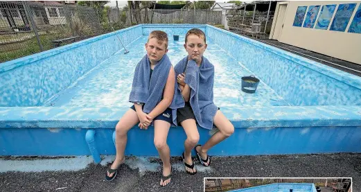 ?? WARWICK SMITH/ STUFF ?? Longburn School pupils Lochie, left, and Tyler Robinson are disappoint­ed work on the school pool hasn’t been completed and they can’t swim in it. The pool needs to be resurfaced before it can be used.