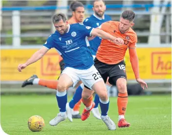  ??  ?? Queen of the South’s Michael Paton gets away from Dundee United’s Calum Butcher