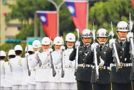  ?? Ritchie B. Tongo EPA/Shuttersto­ck ?? TROOPS PERFORM a drill during National Day celebratio­ns in Taipei, Taiwan. President Tsai Ing-wen wants to raise defense spending.