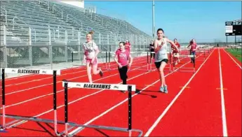  ?? TIMES photograph by Annette Beard ?? Seventh-grade track athletes practice on the new track with hurdles. A junior high track meet was slated for Tuesday afternoon for the first track meet hosted by Pea Ridge.