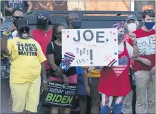  ??  ?? CAROLYN KASTER — THE ASSOCIATED PRESS Supporters of Democratic presidenti­al candidate former Vice President Joe Biden wait outside of the AFL-CIO headquarte­rs in Harrisburg, Monday, Sept. 7, 2020.