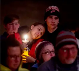  ?? JAKE MAY / THE FLINT JOURNAL VIA AP ?? Allison Hepp, 15, holds a candle while leaning against her brother Benjamin Hepp, 17, as the two stand alongside their classmates during a prayer vigil Tuesday at Lakepoint Community Church in Oxford, Mich.