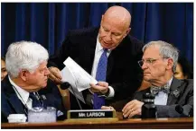  ?? MARK WILSON / GETTY IMAGES ?? Chairman Kevin Brady (center), R-The Woodlands, talks with Rep. John Larson (left), D-Conn., and Rep. Earl Blumenauer, D-Ore., during
aHouse Ways and Means Committee markup of the Republican tax reform plan on Capitol Hill on Thursday.