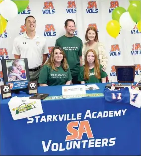  ?? ?? Starkville Academy girls soccer player Melanie Echols, seated right, celebrated her signing with Belhaven University with family and coaches on Wednesday morning. (Photo by Olivia Moore, for Starkville Daily News)