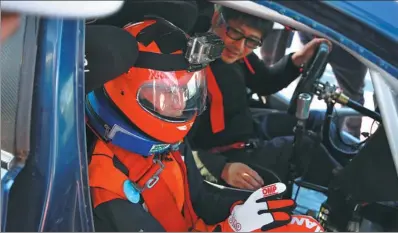  ?? PHOTOS BY BEING ARTSPACE / FOR CHINA DAILY ?? Han Han prepares to drive Yang Tao round the Zhejiang Circuit in Shaoxing, Zhejiang province.