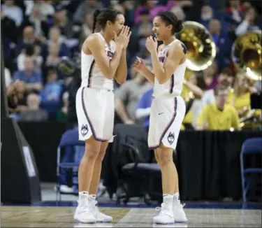  ?? JESSICA HILL — THE ASSOCIATED PRESS ?? UConn’s Napheesa Collier, left, and Gabby Williams share a light moment during the second half of Monday’s game in Bridgeport.